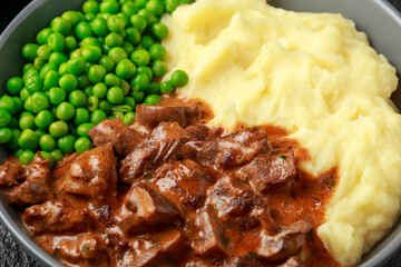 Slow Cooked Steak Diane Casserole with mushroom. mashed potatoes and green peas