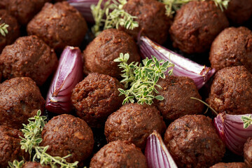 Thyme and onion vegetarian vegan meatballs oven baked in cast iron skillet frying pan