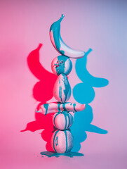 Fluorescent colored fruit and vegetables with a dripping blue paint standing upright. Creative food concept. Abstract and unusual neon natural composition.