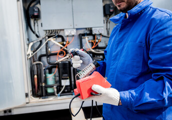 Fototapeta premium The technician repair electronic temperature sensors with an electronic soldering iron