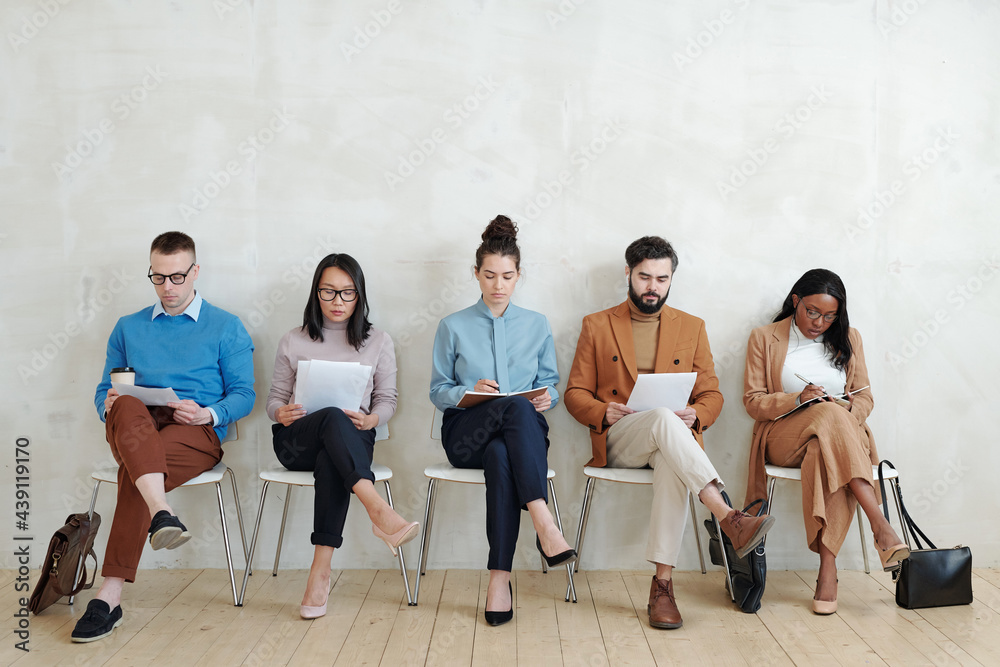 Wall mural candidates for jobs sitting with papers