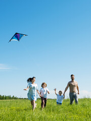 Happy family fly a kite
