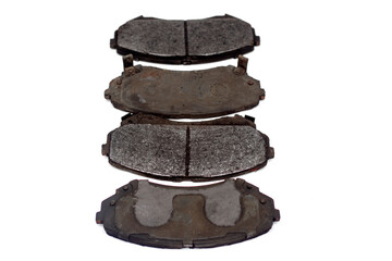 Old brake pads must be replaced on an isolated white background. Very worn out brake pads...