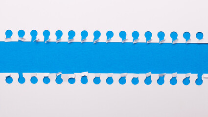 On a blue background with a place to insert text, two white torn strips of paper. Template