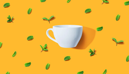 Obraz na płótnie Canvas Fresh mints with tea cup overhead view