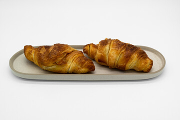 Grilled and delicious croissant on a white background.