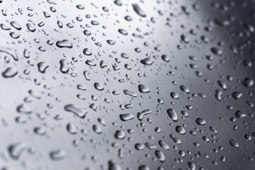 Many different drops of water on the metal surface