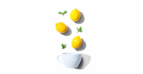 Obraz na płótnie Canvas Fresh yellow lemons with tea cup overhead view