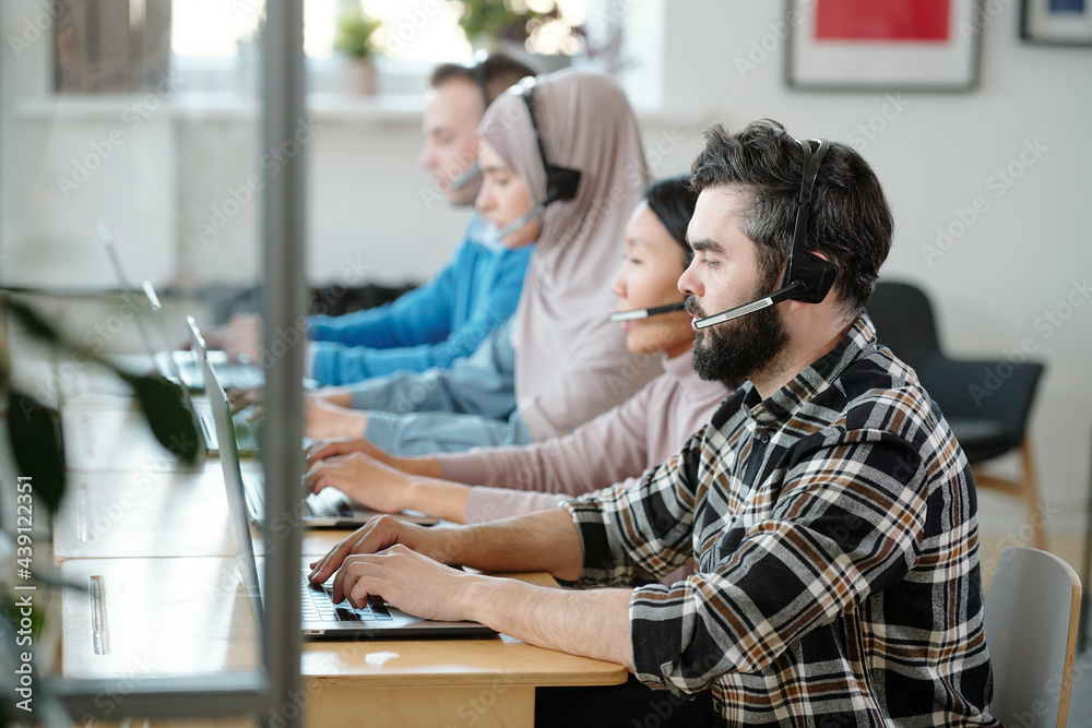 Poster Row of call center operators at work