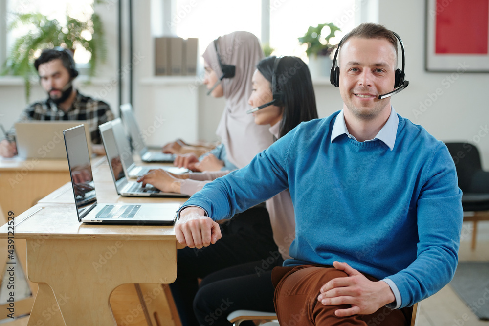 Poster friendly call center operator in headset