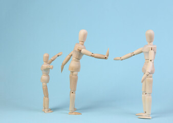 Deprivation of parental rights. Divorce. Family problems concept. The prohibition is seen with the child. Wooden puppets on a blue background