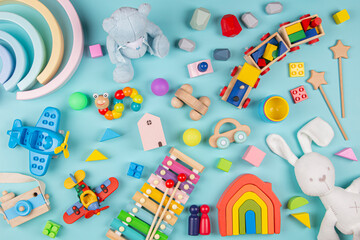 Baby kids toys pattern. Set of colorful educational wooden and fluffy toys on blue background. Top view, flat lay