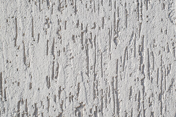 White wall with decorative trim. Texture of the putty for external finishing. Decorative scratches on the surface. Copy space background