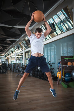 Man Exercising In The Gym With A Heavy Medicine Slam Ball