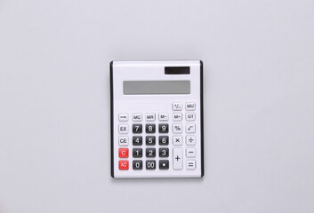 Large white calculator on a gray background. Top view