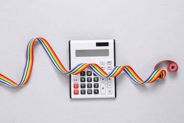 Calculator with lgbt rainbow ribbon on gray background. Top view