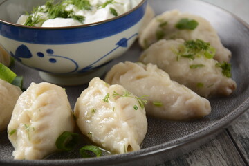 Homemade dumplings, Dagestan cuisine, Kurze. Dumplings kurze with meet filling, and adjika hot sauce  on a plate
