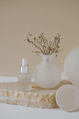 Aesthetic minimalist beauty care therapy concept. Organic serum oil cosmetics bottle on stone with...