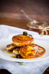 sweet fried cottage cheese pancakes with jam in a plate