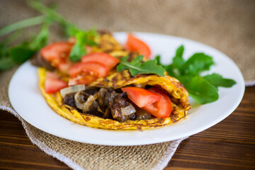 fried egg omelet with wild mushrooms and tomatoes