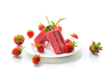 homemade strawberry ice cream on a stick made from fresh strawberries in a plate