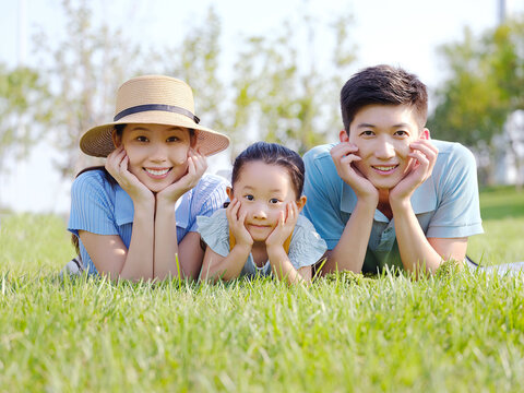 Happy family of three on the grass