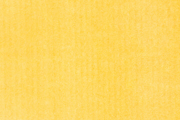 A sheet of yellow colored paper. Rough smooth texture.