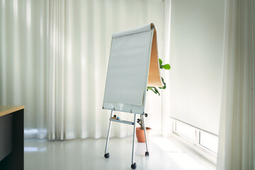 Empty flip board in seminar or training room for present idea or conclusion of brainstorming
