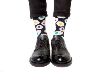 Men's feet in stylish shoes and funny socks