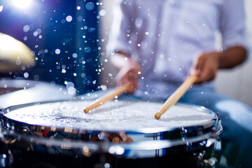 indian man playing the drums sticks close-up in recording studio
