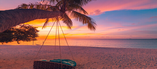 Tropical sunset beach background as summer coast landscape panorama with beach swing or hammock and...