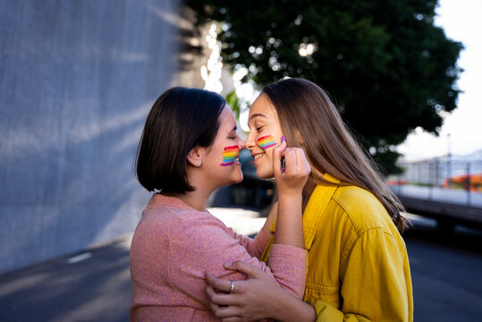 lesbian girls having fun painting themselves and with the lgtb flag on pride day
lgtb concept