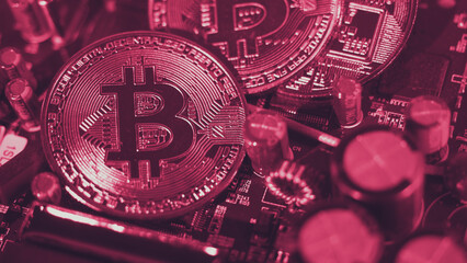 Bitcoin and semiconductor. Represent mining in Cryptocurrency cause global warming. Bitcoins on CPU board. Close-up Bitcoin with blue and pink light. circuit board with coin. Online asset concept. 