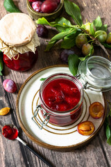 Homemade preservation. Delicious plum jam on a rustic wooden table.