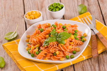 Fusilli pasta with peas and sweet corn.