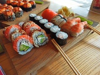 Japanese sushi food. Maki and rolls. Top view of assorted sushi. Serving on a wooden board 