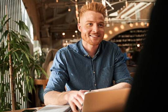 Man sitting at the laptop in front of the job applicant and listening
