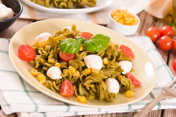 Fusilli pasta with cherry tomatoes and sweet corn.