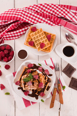 Waffles with raspberries and chocolate cream.