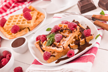 Waffles with raspberries and chocolate cream.