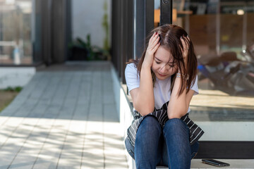 Image of a small business owner feeling a headache and stress with the business of the shop.