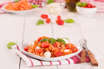 Fusilli pasta with cherry tomatoes and mozzarella cheese.