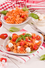 Fusilli pasta with cherry tomatoes and mozzarella cheese.