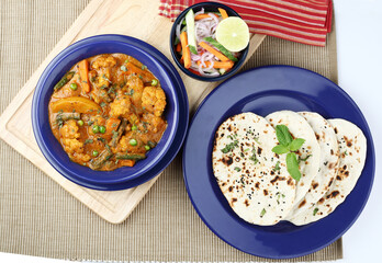 Dinner preparation of various indian food menus Mixed veg curry naan or  roti chapati or Indian Flat bread