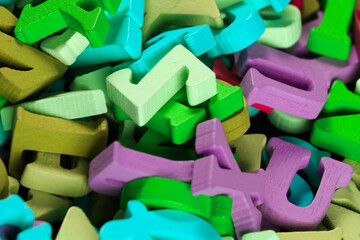 Naklejka premium Many colored wooden letters close up.