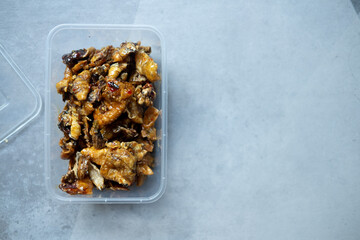 Thai spicy squid snack, deep fried squid with sweet chili sauce recipe in plastic box