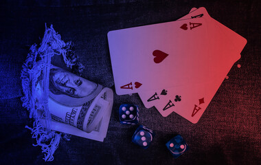 Four aces, dice with a hundred dollar bill through a torn hole in ripped jeans. Neon light