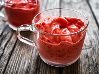 Strawberry ice cream on wooden background
