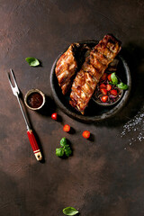 Grilled pork bbq ribs served with cherry tomatoes