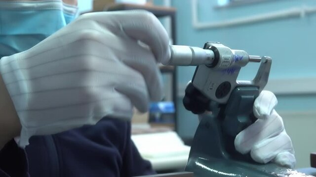 Engineer working with precise micrometer with digital display for quality control. Close up horizontal video of accurate measuring instrument. Micrometer tool showing the exact diameter and thickness.